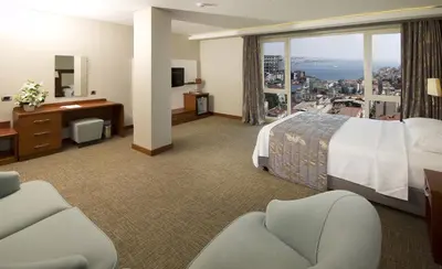 a hotel room with a bed and a large window at Innpera Hotel in Istanbul