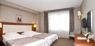 a hotel room with two beds and a window at Innpera Hotel in Istanbul