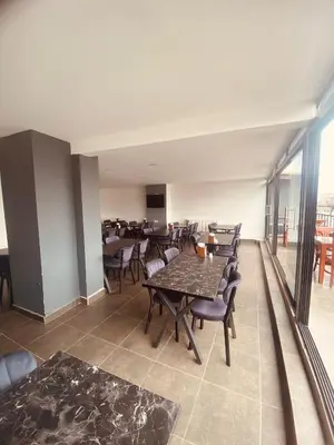 a dining room with tables and chairs and a balcony at Malkoç Hotel in Istanbul