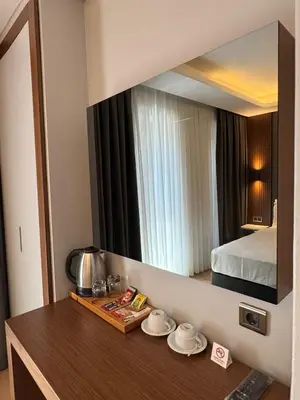 a hotel room with a mirror on the wall at Center Hill Hotel in Istanbul