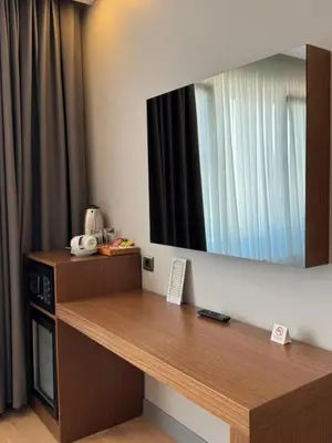 a room with a desk with a television on the wall at Center Hill Hotel in Istanbul