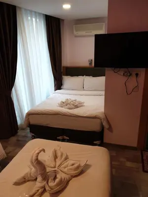 a hotel room with two beds with towels on them at Gulhane Corner Hotel in Istanbul