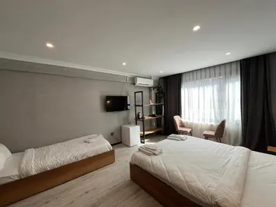 a hotel room with two beds and a television at Le Safran Suite Hotel in Istanbul