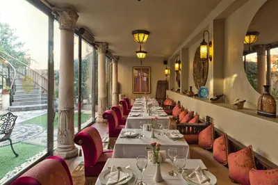 a row of tables in a restaurant with red chairs at Sokullu Pasa Hotel - Special Class in Istanbul