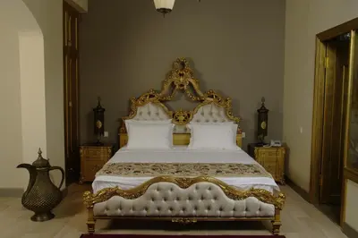 a bedroom with a large white bed with golditures at Sokullu Pasa Hotel - Special Class in Istanbul