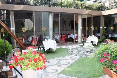 a restaurant with tables and chairs and flowers at Sokullu Pasa Hotel - Special Class in Istanbul