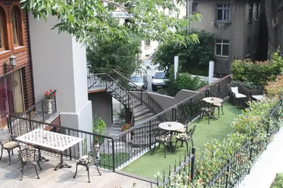 a balcony with tables and chairs and a staircase at Sokullu Pasa Hotel - Special Class in Istanbul