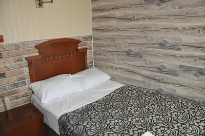 a bed in a room with a wooden wall at Hotel Red Rose in Istanbul
