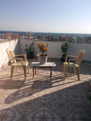 a patio with two chairs and a table on a roof at Hotel Red Rose in Istanbul