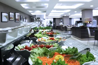 a buffet line with many plates of vegetables on display at Benler Otel Laleli ISTanbul in Istanbul