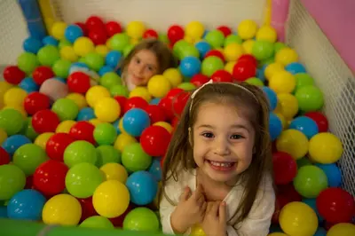 a little girl in a pool of balls at Somerset Maslak Istanbul in Istanbul