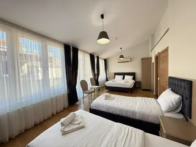 a hotel room with two beds and a couch at Taksim Istiklal Street Next2 Hotel in Istanbul