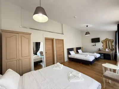 a bedroom with two beds and a living room at Taksim Istiklal Street Next2 Hotel in Istanbul