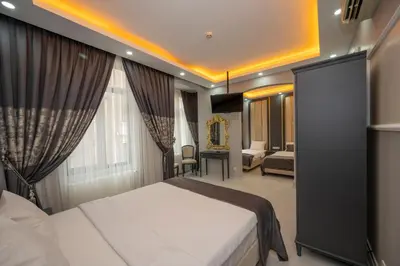 a hotel room with a bed and a living room at Taksim Istiklal Street Next2 Hotel in Istanbul