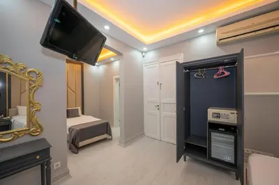 a room with a tv and a bedroom with a bed at Taksim Istiklal Street Next2 Hotel in Istanbul