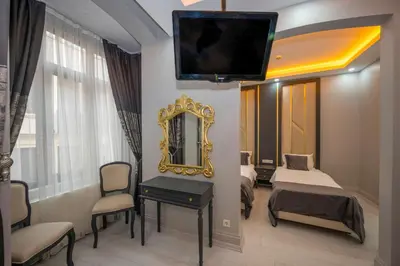 a hotel room with two beds and a mirror at Taksim Istiklal Street Next2 Hotel in Istanbul
