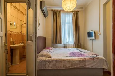 a bedroom with a bed and a sink and a window at Erenler HoTeL & HosTeL in Istanbul