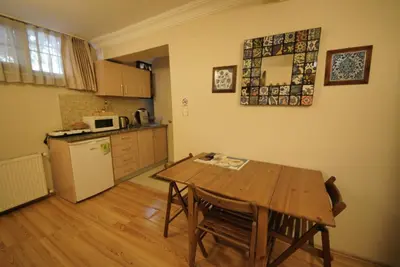 a kitchen with a wooden table and a wooden floor at Topkapi Apartments in Istanbul