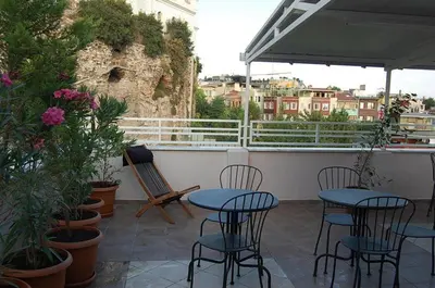 a patio with tables and chairs and plants on a balcony at Topkapi Apartments in Istanbul