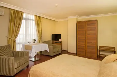 a hotel room with a bed and a table at Grand Gebze Hotel in Gebze