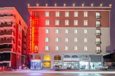 a tall building with a store in front of it at Grand Gebze Hotel in Gebze