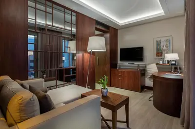 a living room with a couch and a tv at Doubletree By Hilton Istanbul Topkapi in Istanbul