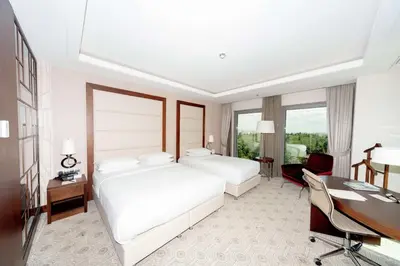 a hotel room with two beds and a desk at Doubletree By Hilton Istanbul Topkapi in Istanbul