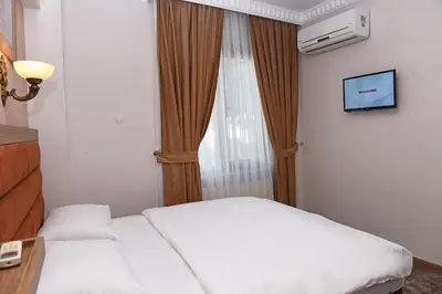 a hotel room with a bed and a window at Hotel Grand Umit in Istanbul