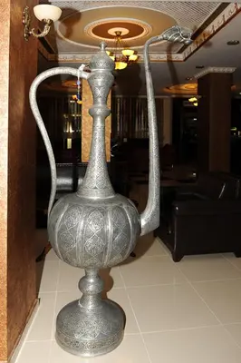 a silver vase sitting on the floor in a room at Hotel Grand Umit in Istanbul