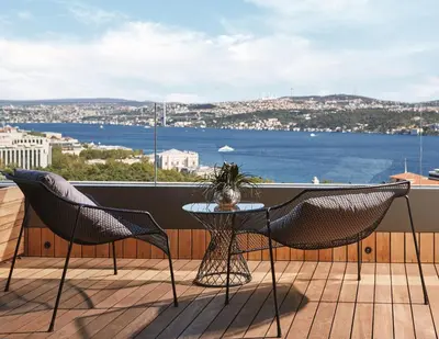 a balcony with a table and chairs and a view of the water at Gezi Hotel Bosphorus, Istanbul, a Member of Design Hotels in Istanbul
