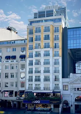 a large building with a double decker bus in front of it at CVK Taksim Hotel Istanbul in Istanbul