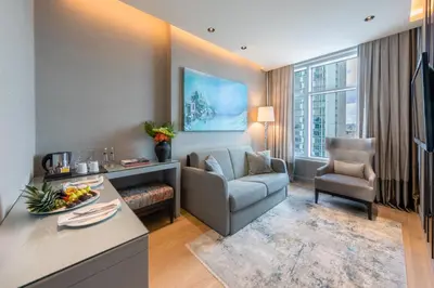 a living room with a couch and a chair at CVK Taksim Hotel Istanbul in Istanbul