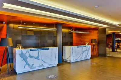 a lobby with two marble tables in a building at Hotel Anatolia in Bursa