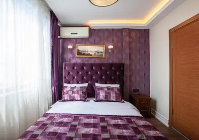 a purple bedroom with a bed with a purple headboard at Rose Mansion by Otantik Suites in Istanbul
