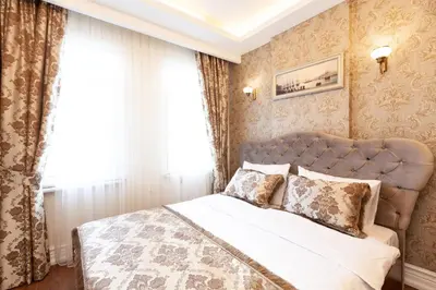 a bedroom with a large bed and a window at Rose Mansion by Otantik Suites in Istanbul