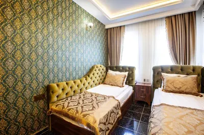 a hotel room with two beds and a wall at Rose Mansion by Otantik Suites in Istanbul