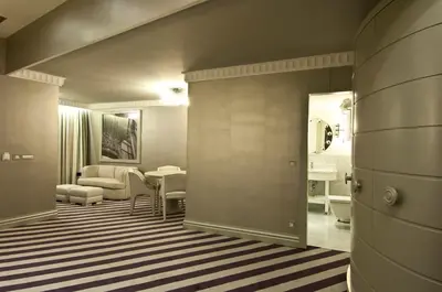a hallway with a living room with a table at Taxim Hill Hotel in Istanbul