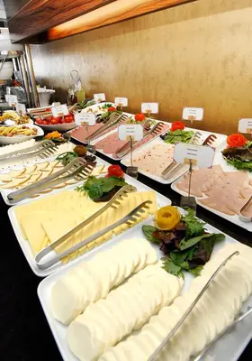 a table with many different types of cheese on it at Taxim Hill Hotel in Istanbul