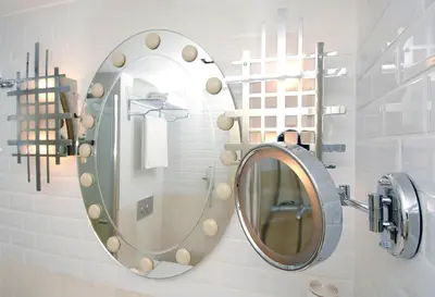 a bathroom with a round mirror on a wall at Taxim Hill Hotel in Istanbul