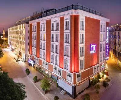 an apartment building with a neon sign on it at Vicenza Hotel Istanbul Old City in Istanbul