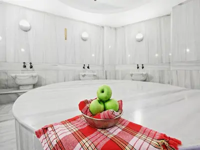 a bowl of green apples sitting on top of a table at Vicenza Hotel Istanbul Old City in Istanbul