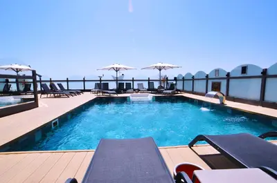 a swimming pool with chairs and umbrellas on a building at Vicenza Hotel Istanbul Old City in Istanbul