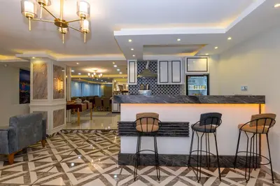 a kitchen and living room with a bar with stools at Hotel Yesilpark in Istanbul