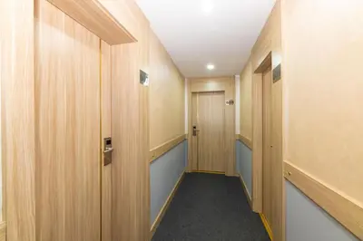 a hallway with wooden panels and a door at Hotel Yesilpark in Istanbul
