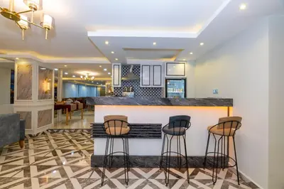 a kitchen with a bar with stools at Hotel Yesilpark in Istanbul