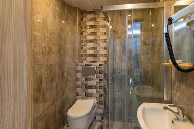 a bathroom with a toilet and a shower and a sink at Hotel Yesilpark in Istanbul