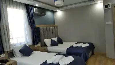 a hotel room with two beds with towels on them at Hotel Yesilpark in Istanbul