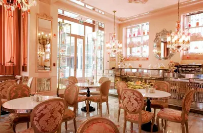 a restaurant with tables and chairs and windows at Pera Palace Hotel in Istanbul
