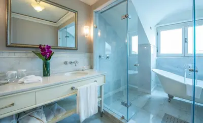 a bathroom with a tub and a sink and a shower at Pera Palace Hotel in Istanbul