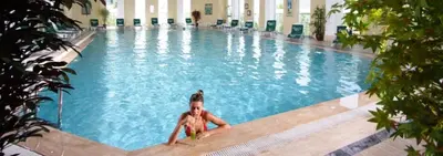 a woman is laying in a swimming pool at EmexOtel Kocaeli in Kocaeli